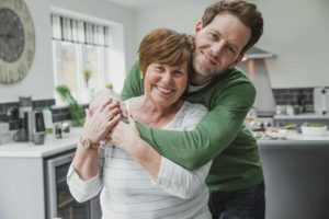 photo of son hugging mom in kitchen